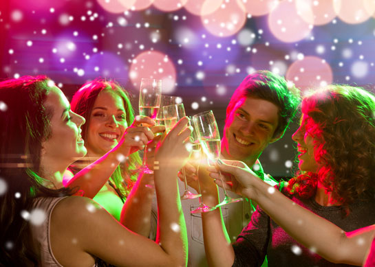 Party scene with glasses of sparkling wine in toast 
