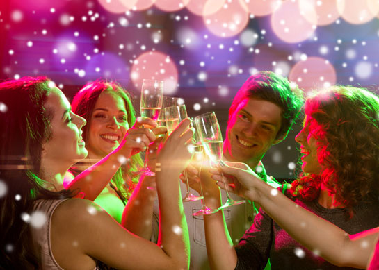 Party scene with glasses of sparkling wine in toast