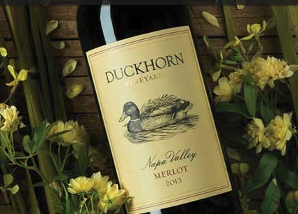 detail Duckhorn 2013 Three Palms Vineyards bottle of Merlot with yellow flowers in background